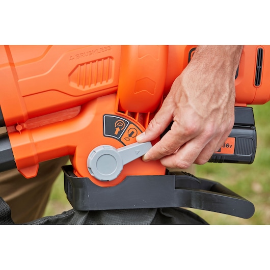 Photo of BLACKDECKER BCBLV36B leaf blower close-up showing control lever and battery section.