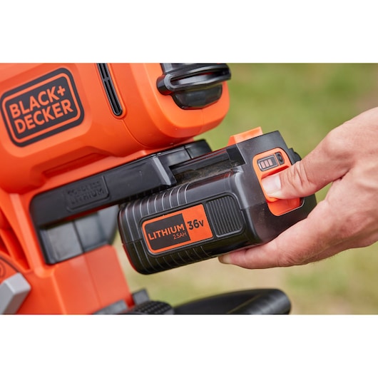 BLACKDECKER BCBLV36B lithium 36V battery being inserted into orange cordless tool, close-up angle.