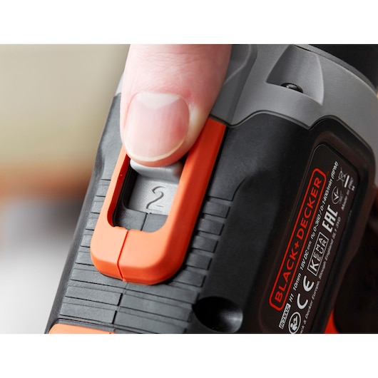 Close-up photo of a BLACK+DECKER BCD003C1 power tool handle with an orange speed selector switch set to 2.