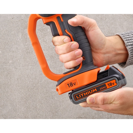 Photo of BLACKDECKER BCG720M1 power tool handle with orange 18V lithium 2.0Ah battery, hand holding tool.