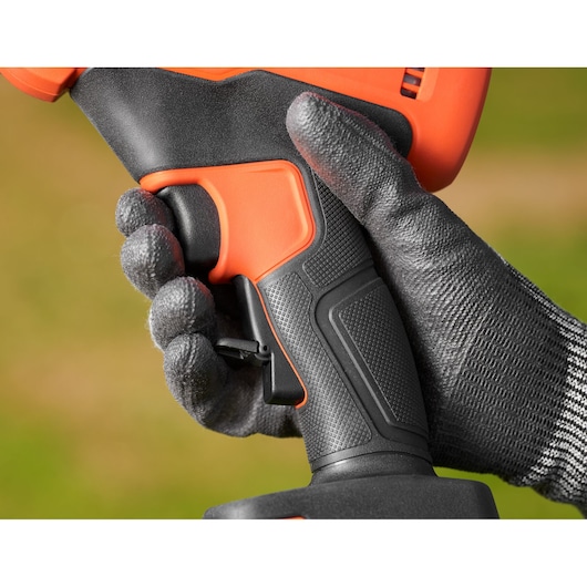 Close-up photo of BLACK+DECKER BCPP18D1 power tool handle held by a gloved hand, showing textured grip and trigger.