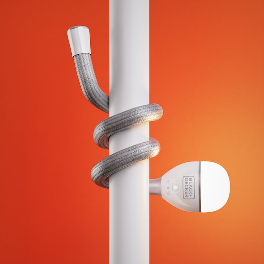Photo of BLACK+DECKER BDCFSL01 flexible LED lamp wrapped around a white pole, orange background.