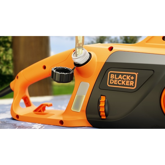 Close-up photo of BLACK+DECKER BECS1835 orange chainsaw, side oil filling port open, visible oil level window.