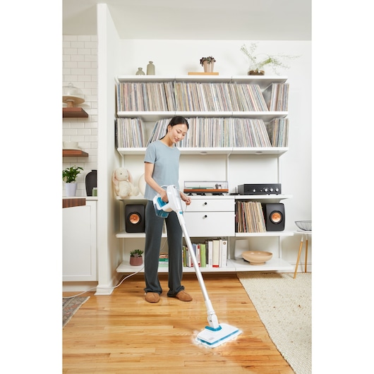 BLACKDECKER BHSM15FX08 steam mop cleaning hardwood floor in living room setting.
