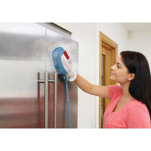 BLACKDECKER BHSM168DSM steam cleaning glove cleaning stainless steel refrigerator door in kitchen.