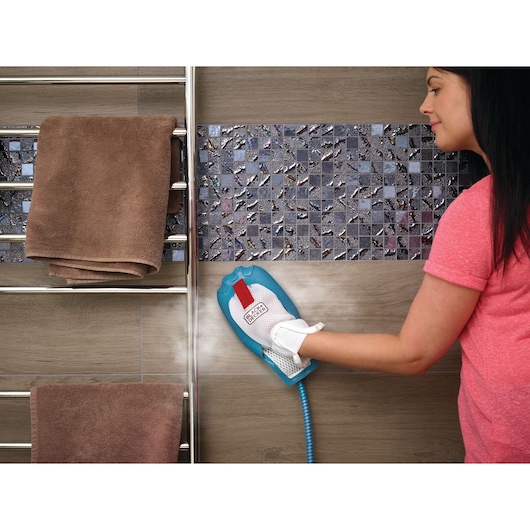 BLACKDECKER BHSM168DSM steam cleaning glove used on tiled bathroom wall near towel rack.