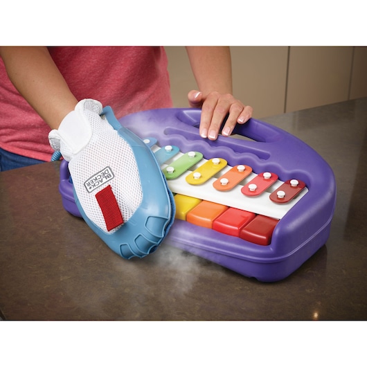 BLACKDECKER BHSM168DSM steam cleaning glove cleaning colorful plastic xylophone on countertop.