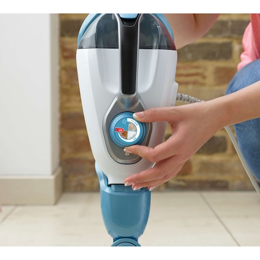 BLACKDECKER FSMH1321 steam mop with blue control dial being adjusted, close-up photo.