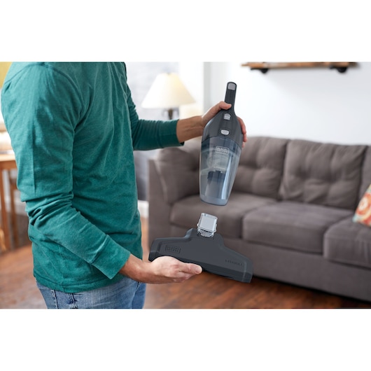 Photo of BLACKDECKER NSVA315J handheld vacuum with detachable floor head in a living room setting.